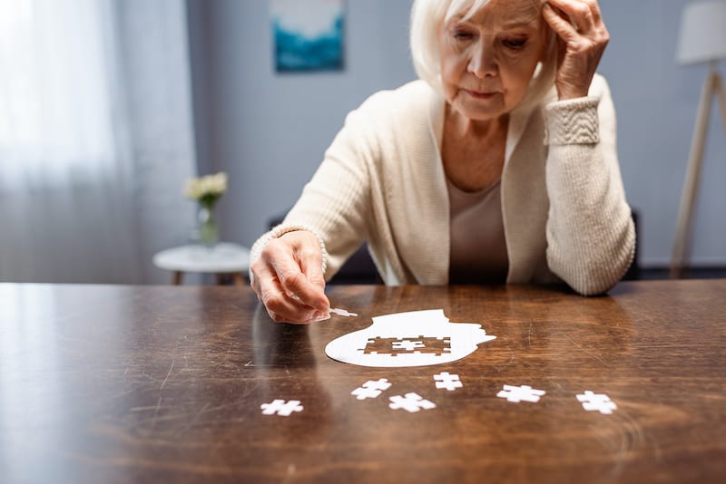 Senior Woman doing a puzzle for dementia