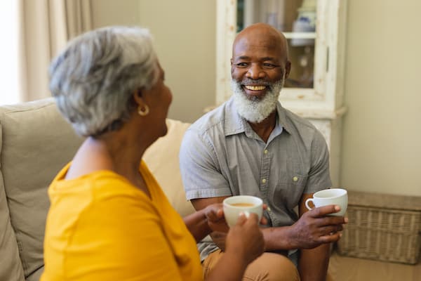 Senior Couple smiling drinking coffee