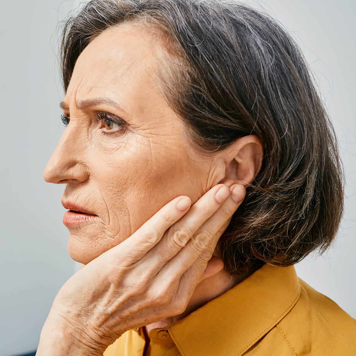Woman holding ear