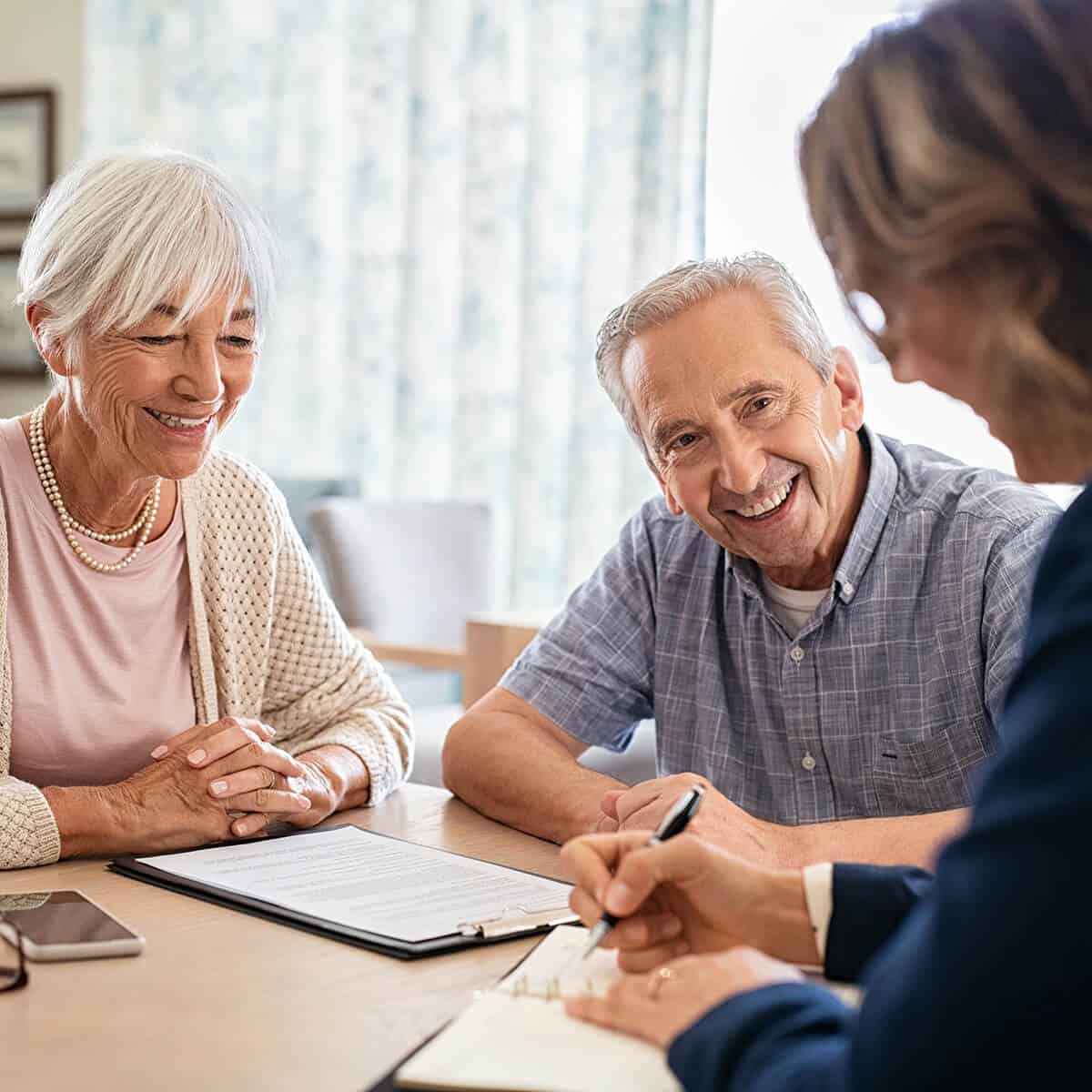 elderly couple talking to an important individual